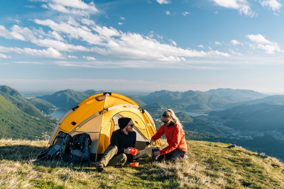 couple-camping-on-mountain-top-prepare-food-and-royalty-free-image-1645543122.jpg